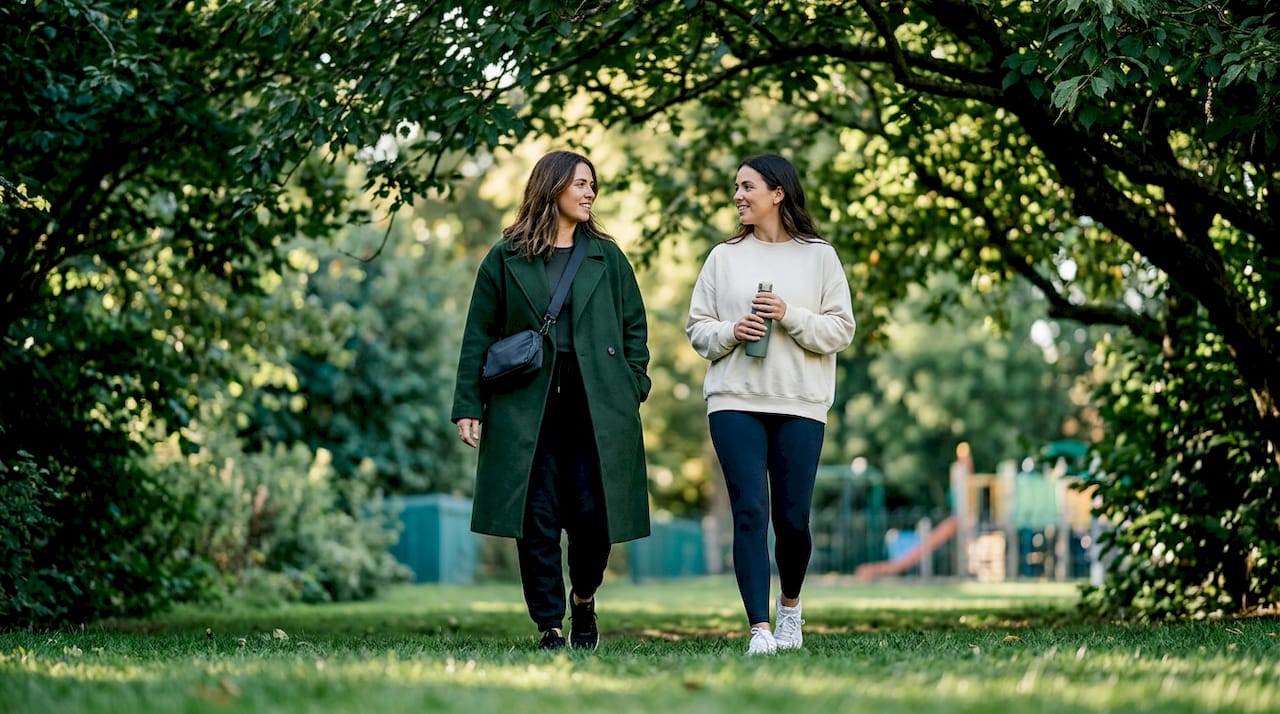 Women in activewear walking city sidewalk